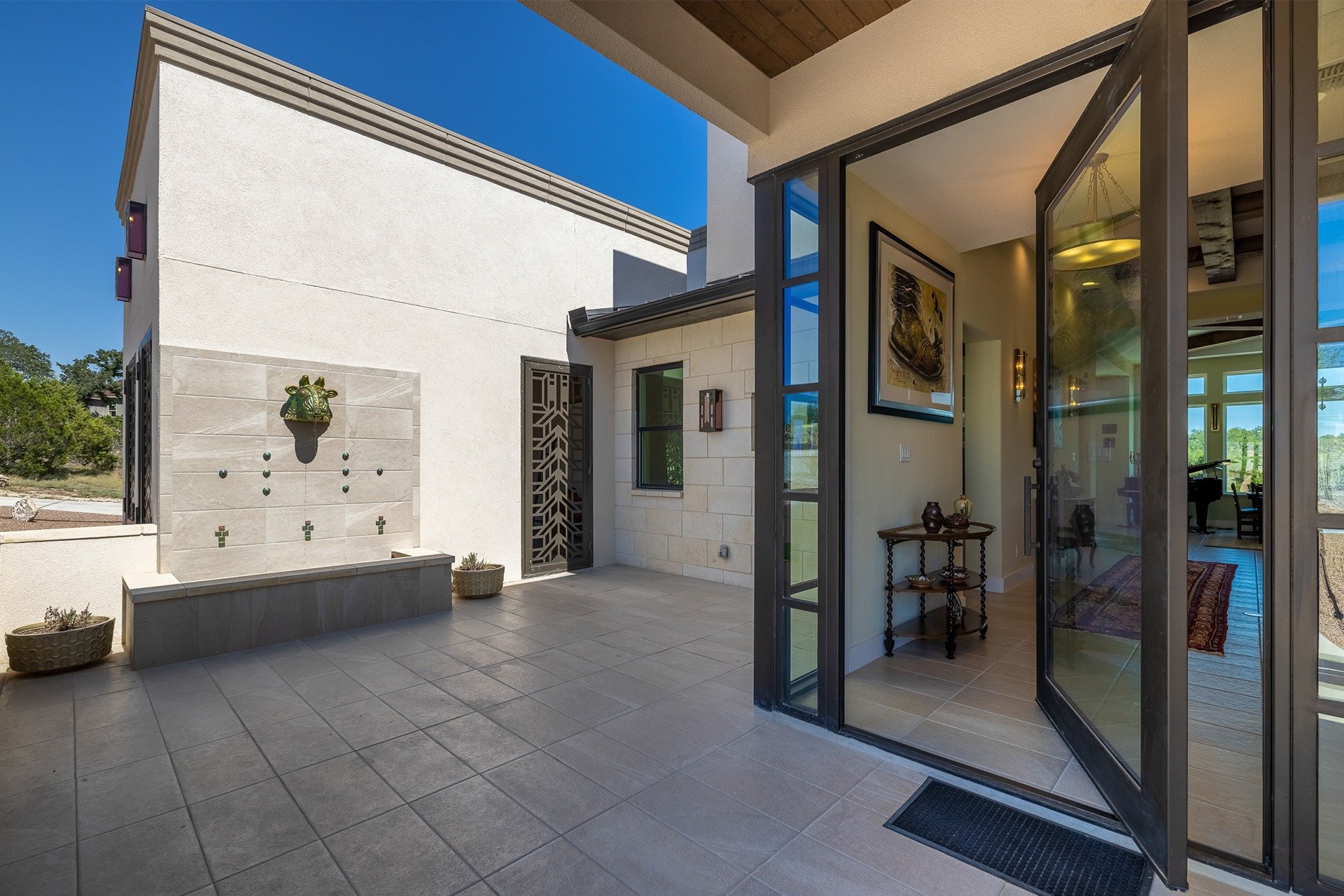 Pivot entry door onto a stone courtyard